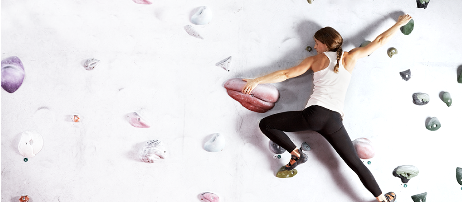 woman climbing on rock climbing wall